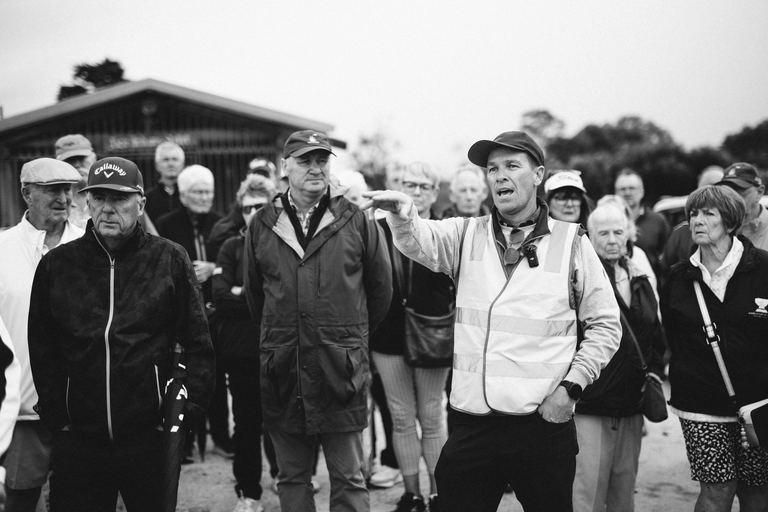 Members on a course walk with OCM Golf at Long Island, in black and white