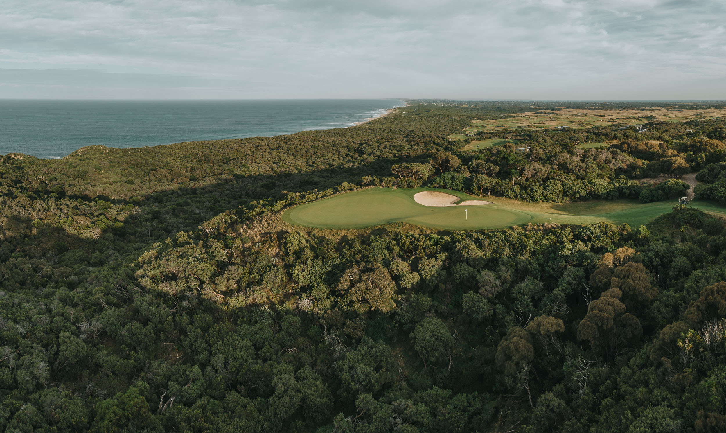 The seventh hole of The National's Old Course from the air, the ocean beyond